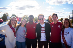 A group of Indiana University students smiling with arms around each other.